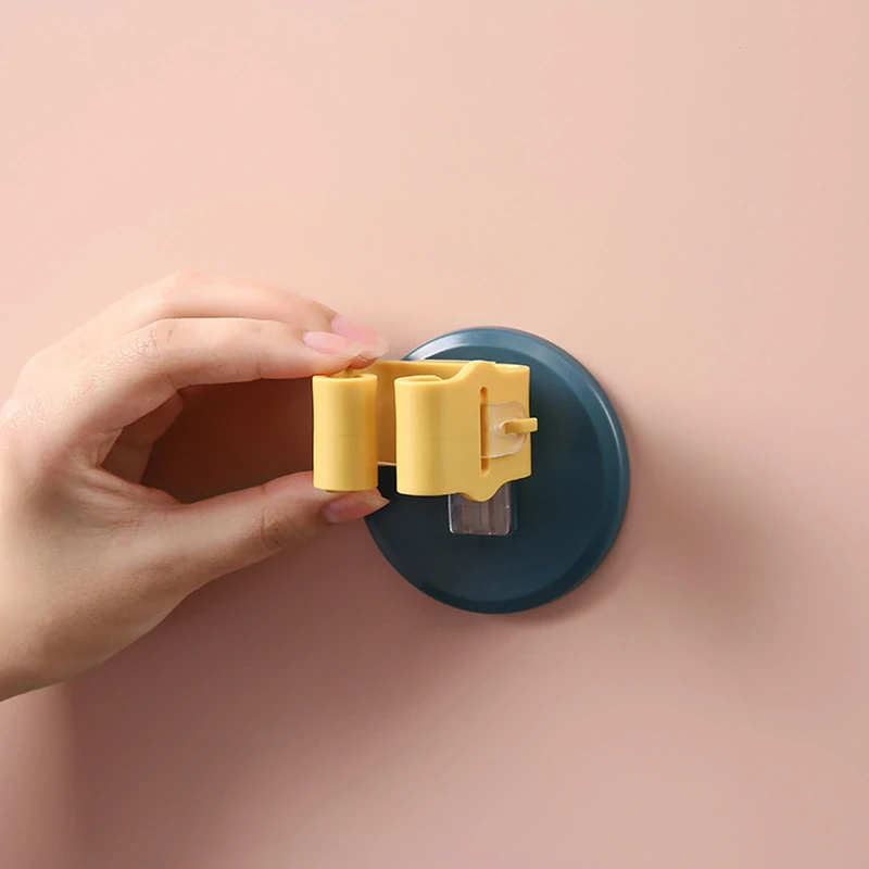 Samolepiaci nástenný držiak na mop zeleno biely